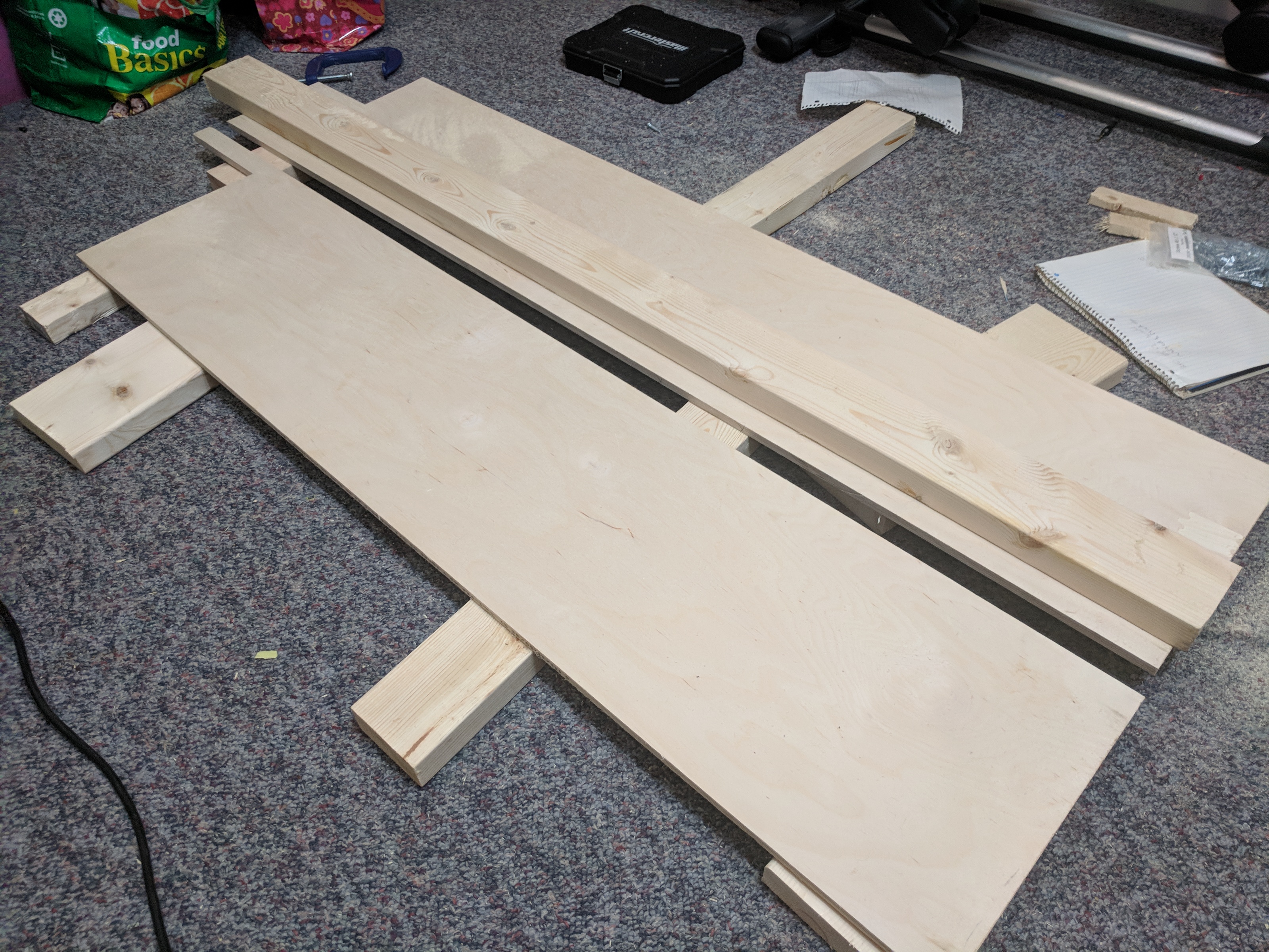 Cuting plywood with a circular saw. 2x4 as my 'straight' edge.